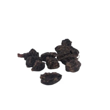 Load image into Gallery viewer, Dark brown dried fruit pieces on a white background