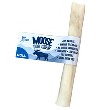 Load image into Gallery viewer, A rolled-shaped dog chew made from moose hide, placed on a wooden surface with a label that provides product information.