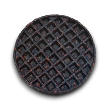 Load image into Gallery viewer, A round cast iron waffle plate or griddle insert with a dark, rustic textured finish, shown from a top-down view on a white background.