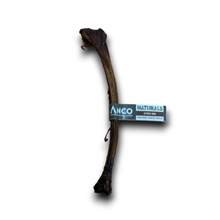 Load image into Gallery viewer, A natural bone-shaped dog chew with a dark brown textured surface, featuring a paper band label that reads 'Anco Naturals Dutch Bone'.