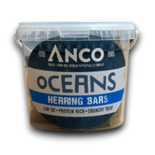 Load image into Gallery viewer, A clear plastic tub of Anco Oceans Herring Bars dog treats, showing the dark blue and white branded label and the treats inside, on a white background.