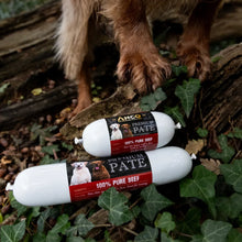 Load image into Gallery viewer, Two packages of Ancor Premium Pate 100% Pure Beef dog food on green leaves with a dog's paw in the background.