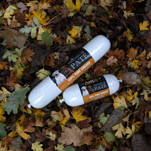 Load image into Gallery viewer, Two dog treats on a bed of autumn leaves