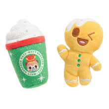 Load image into Gallery viewer, Two plush dog toys on a white background: a green holiday coffee cup toy with white foam, red rim, and a cartoon bear logo, and a yellow gingerbread person toy with white trim and green buttons.