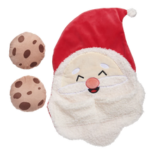 Load image into Gallery viewer, A plush Santa Claus face hat with a red hat, white fluffy beard, embroidered smiling face, and two small chocolate chip cookie plushies beside it on a plain white background.