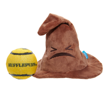 Load image into Gallery viewer, A brown plush Sorting Hat dog toy with a sad face and a yellow tennis ball that says HUFFLEPUFF, shown on a plain white background.