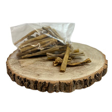 Load image into Gallery viewer, Dried dog treats on a wooden board with a clear plastic bag.