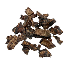 Load image into Gallery viewer, Dried brown pieces of meat on a white background