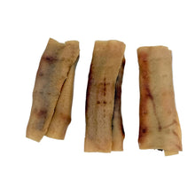 Load image into Gallery viewer, Three rolled, dried strips of food, resembling spring rolls or spring rolls with filling, displayed on a plain white surface.