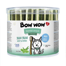 Load image into Gallery viewer, A clear plastic tub of Bow Wow Dental Snack for dogs, filled with cucumber sticks, featuring a white and green label with a cartoon husky and text for 'Yum Yum Mint & Herbs' with kelp flavor.