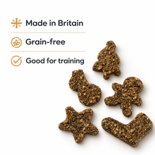 Load image into Gallery viewer, Five brown textured dog training treats shaped like a Christmas tree, gingerbread man, star, and boot, displayed on a white background with text highlighting 'Made in Britain', 'Grain-free', and 'Good for training'.