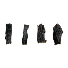 Load image into Gallery viewer, Three pieces of Nova Buffalo Liver treats for dogs, displayed against a white background. The treats are in a state of preservation and have a dark, textured appearance.