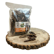 Load image into Gallery viewer, Packaged Camel Tripe dog treats on a wooden surface, with some treats visible outside the package.