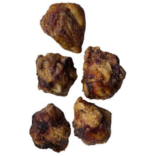 Load image into Gallery viewer, Five pieces of dried beef knuckles on a white paper bag with a cardboard background