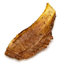 Load image into Gallery viewer, A single dried fish bone snack or jerky piece, showing a textured golden-brown surface, isolated on a white background.