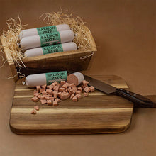 Load image into Gallery viewer, Salmon pate rolls with packaging on a wooden cutting board and box.