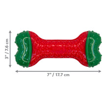 Load image into Gallery viewer, A red and green bone-shaped dog toy with textured grips and raised lettering, shown on a white background with dimension arrows indicating 7 inches by 3 inches.