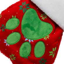Load image into Gallery viewer, Red fabric with green paw prints and snowflakes on a white background
