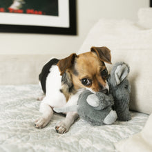 Load image into Gallery viewer, Small dog lying on a bed with a plush toy elephant