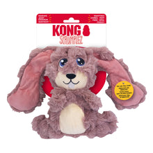 Load image into Gallery viewer, Kong Scrumpiez plush dog toy in its original packaging, featuring a brown and beige plush dog with floppy pink ears and a red inner ear lining, on a white background.