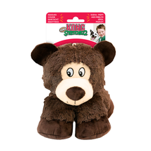 Load image into Gallery viewer, A plush dog toy shaped like a bear, with dark brown fur, a cream-colored snout and face, and a pink and white hanging retail header card. The header card features the brand name 'The KONG Squeakerz' and multilingual product descriptions.