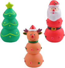 Load image into Gallery viewer, Three Christmas-themed squishy toys on a plain white background: a green Christmas tree with a yellow star, a Santa Claus figure in red and white, and a snowman figure in peach with a red hat and green scarf.