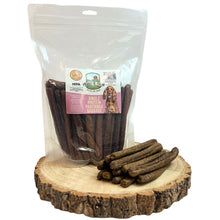 Load image into Gallery viewer, Dog treats in a clear plastic bag on a wooden surface with a visible brand label.