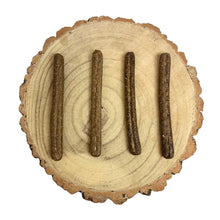 Load image into Gallery viewer, Four dark brown dog treats arranged on a circular wooden board with a white background
