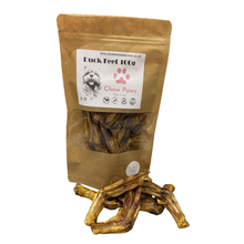 Load image into Gallery viewer, Package of 'Duck Feet' dog treat by Chow Paws with visible duck feet outside the package on a white background.