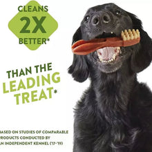 Load image into Gallery viewer, Dog holding a toothbrush with text claiming it cleans 2x better than the leading treat.