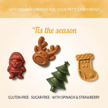 Load image into Gallery viewer, Four festive-shaped dog treats on a beige background with text about wholesome snacks for pets.