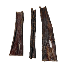 Load image into Gallery viewer, Three flat beef stick treats for dogs placed on a white background.