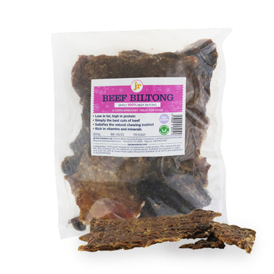 Packaged beef biltong strips displayed in front of a transparent packaging with a label that reads 'BEEF BILTONG'.