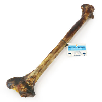 A long bone chew for dogs, with a label indicating it is an ostrich bone.