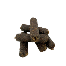 Load image into Gallery viewer, Stack of dark brown dog treats on a white background
