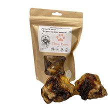 Load image into Gallery viewer, Package of 'Chow Paws' dog treats with two treats in front on a white background
