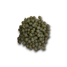 Load image into Gallery viewer, Pile of green fish food pellets on a white background
