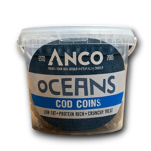 Load image into Gallery viewer, A clear plastic tub of Anco Oceans Cod Coins dog treats, showing the brownish-beige treats inside and a dark blue and white label.
