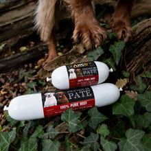 Load image into Gallery viewer, Two packages of Ancor Premium Pate dog food on a natural background with a dog's paw visible.
