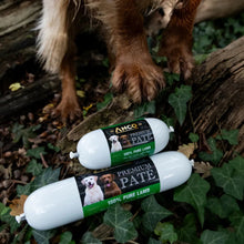 Load image into Gallery viewer, Two ANCO Premium Pate 100% Pure Lamb dog treats on a log with a dog in the background.
