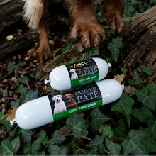Load image into Gallery viewer, Two packages of Ancro Premium Pate dog food on the ground with a dog's paws visible.
