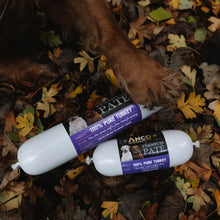 Load image into Gallery viewer, Two ANCO turkey pate cans on a leaf-covered ground with a dog's paw nearby.
