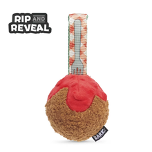 Load image into Gallery viewer, A plush dog toy shaped like a dessert, with a brown textured base, bright red topping, and a striped fabric loop featuring a fork graphic. The words 'RIP AND REVEAL' appear in the top left, and a small black tag with 'SMK' is visible near the bottom right.
