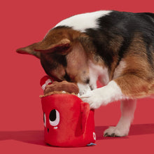 Load image into Gallery viewer, Dog playing with a red plush toy against a red background
