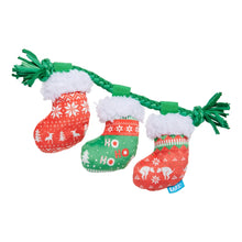 Load image into Gallery viewer, Set of Christmas-themed dog toys resembling stockings with green pull handles on a white background.
