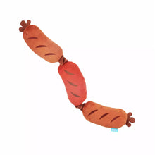 Load image into Gallery viewer, A plush sausage-shaped dog toy with three knotted segments in shades of orange, red, and brown, shown on a plain white background.
