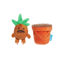 Load image into Gallery viewer, A Lark plush dog toy shaped like a grumpy pineapple next to its orange fabric pot, shown on a plain white background.

