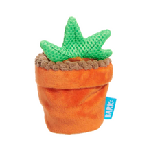 Load image into Gallery viewer, An orange plush carrot-shaped dog toy with a green textured leafy top and a small blue BARK brand tag, shown on a plain white background.
