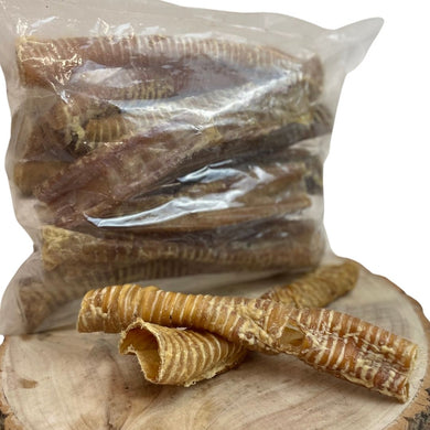 Packaged buffalo trachea dog chews displayed on a wooden surface.