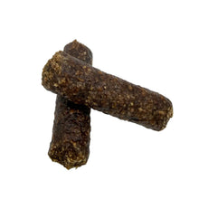 Load image into Gallery viewer, Two dark brown, textured cylindrical dog treats crossed on a light gray background.
